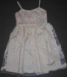 Beautiful cream colored satin dress with spaghetti straps has a 