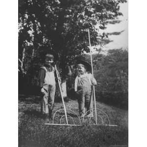  Two Young Farm Boys Wearing Straw Hats and Holding Rakes 