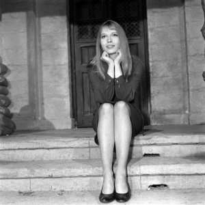  Mia Farrow in London Sitting on Steps in Front of Doorway 