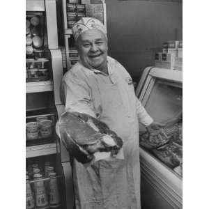  Grocer E.G. Guthart Displaying One of His Steaks Stretched 