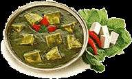 Soft cubes of cottage cheese simmered in fresh spinach puree, creating 